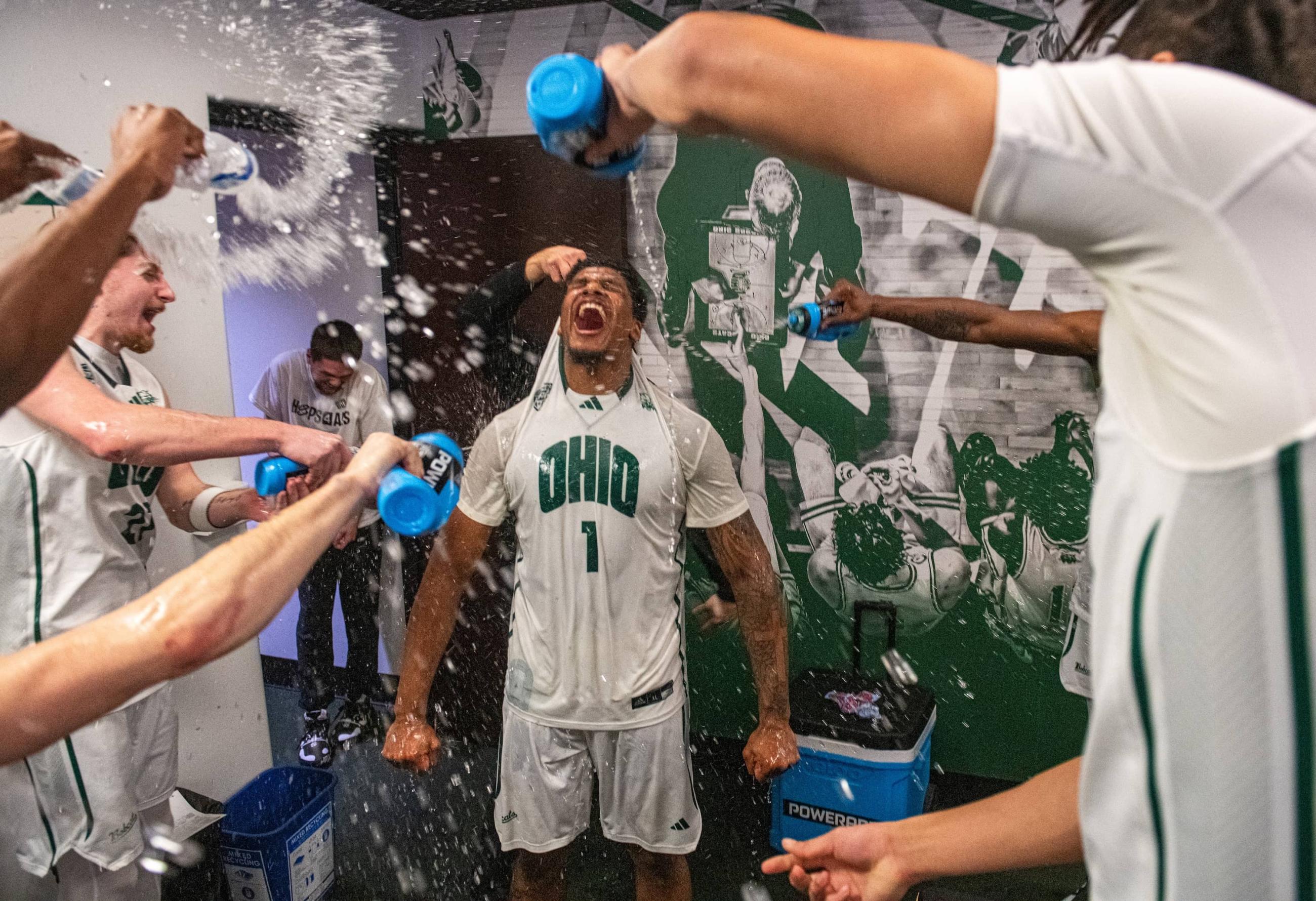 Javan Simmons celebrates with teammates in the locker room