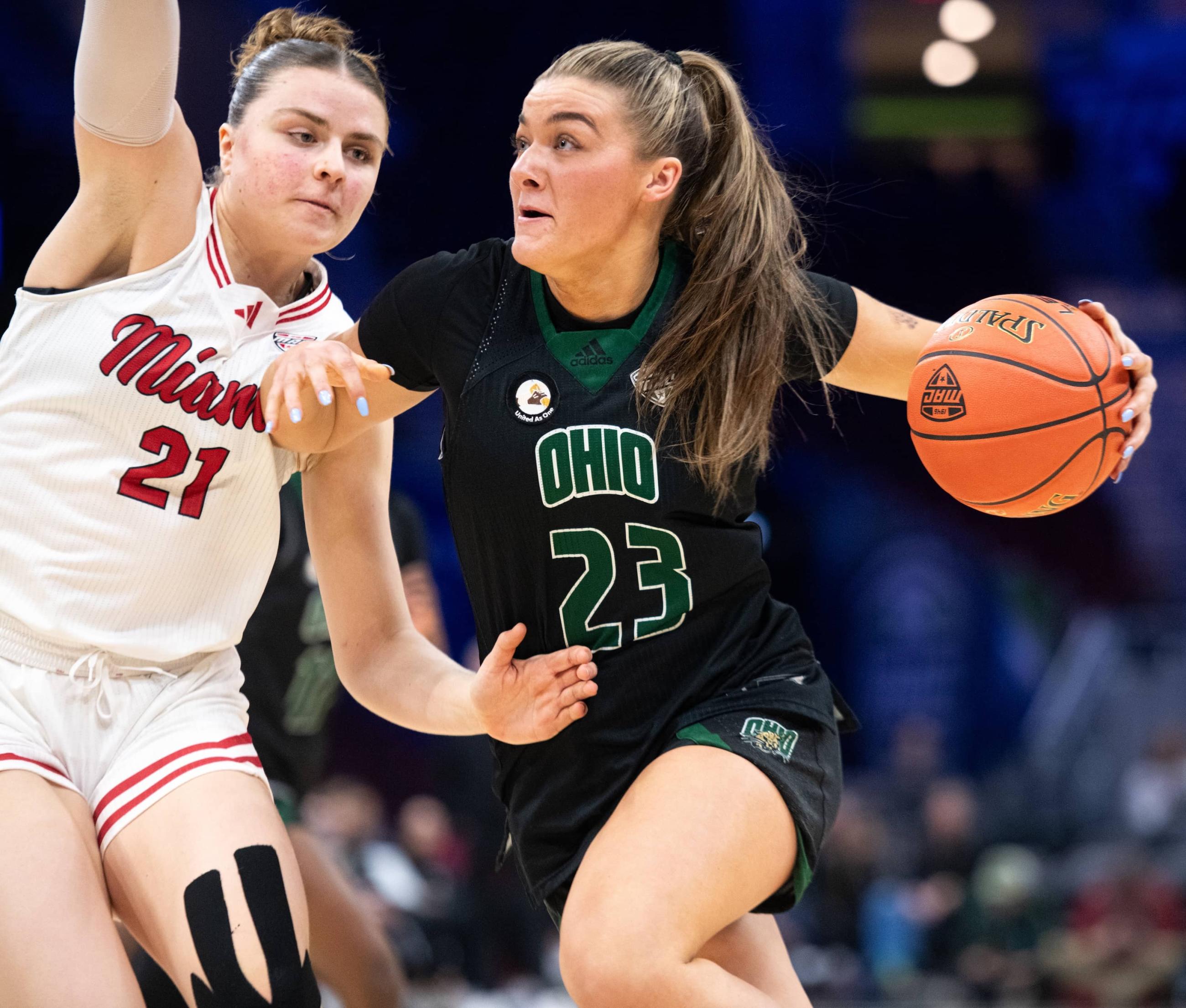 Danni Scully drives the ball to the hoop against a RedHawk defender