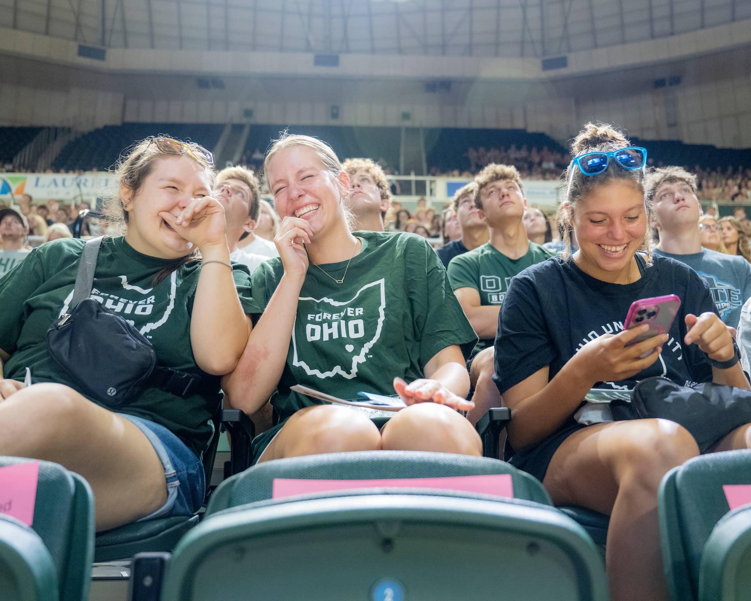 3 first year students laugh while sitting in the Convo during OHIO's Welcome Week