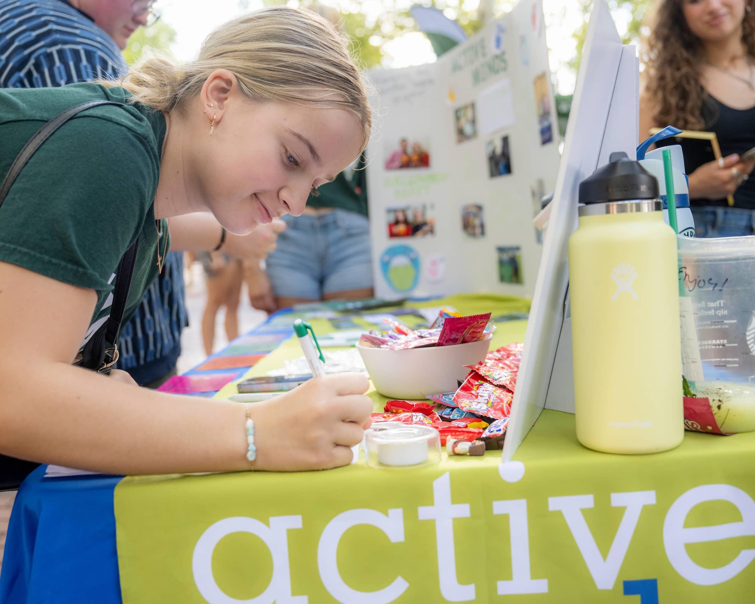 A student signs up for an organization during OHIO's Welcome Week