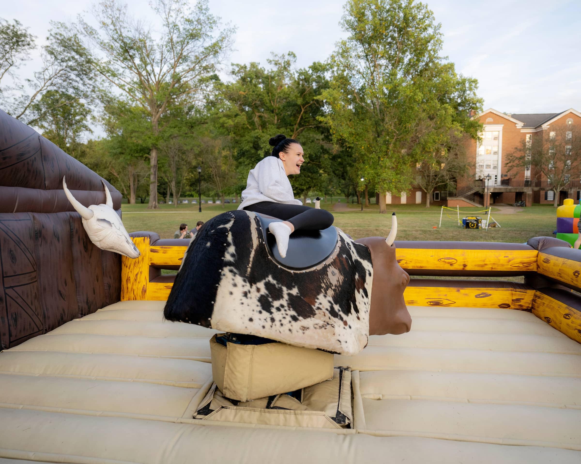 A student rides a mechanical bull during OHIO's Welcome Week