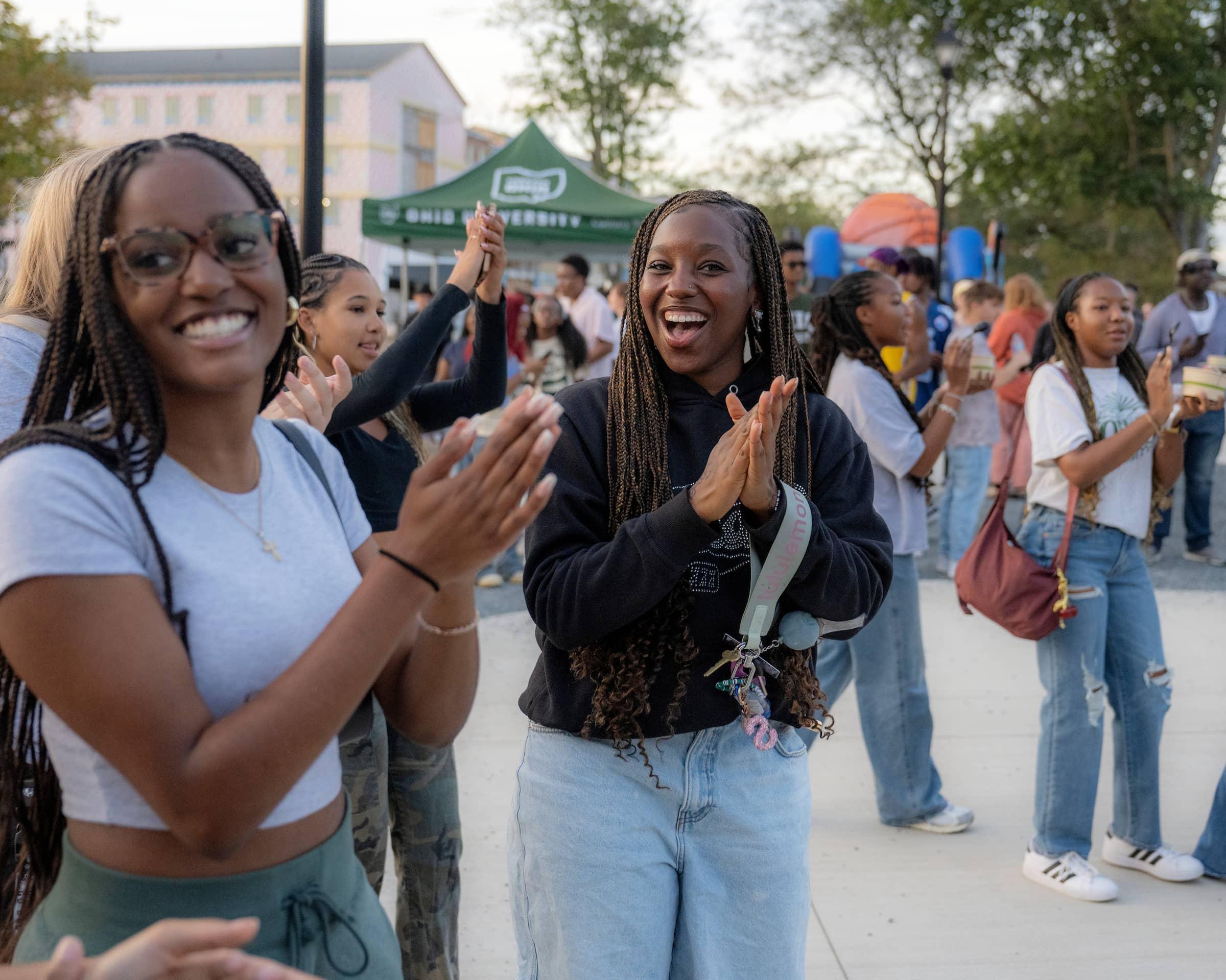 2 students smiling and clapping during OHIO's Welcome Week