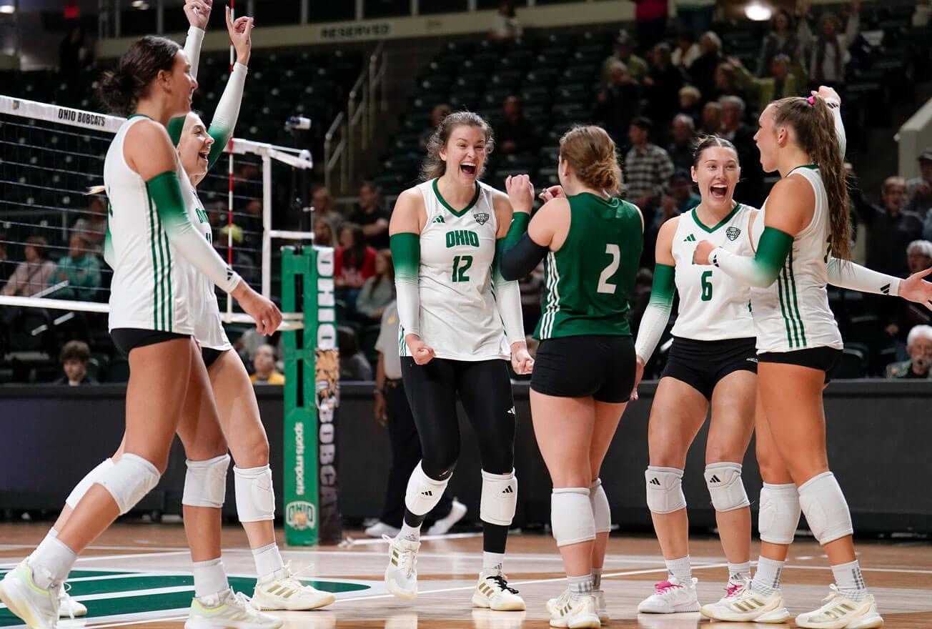 Ohio University women's volleyball team celebrates after scoring.