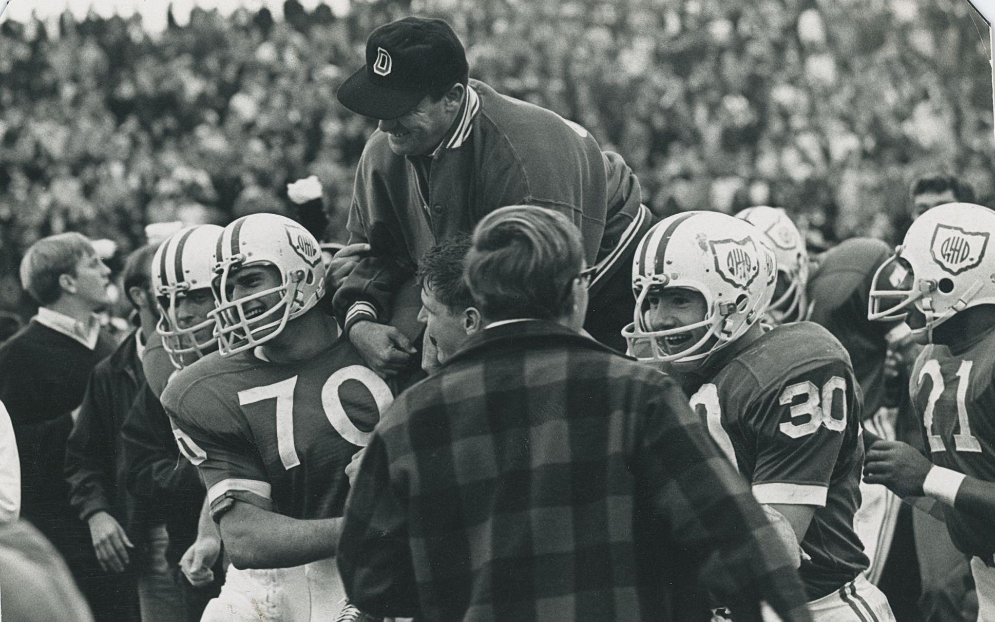 old black and white photo of Bill Hess and football players