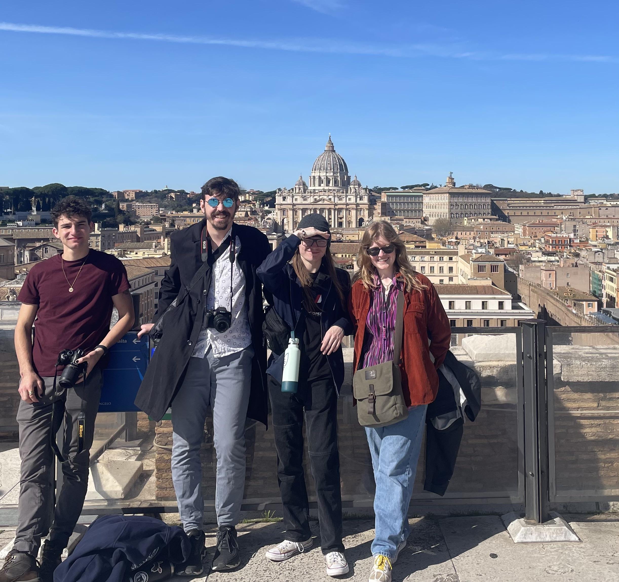 4 students pose on a sunny day in Rome, Italy.