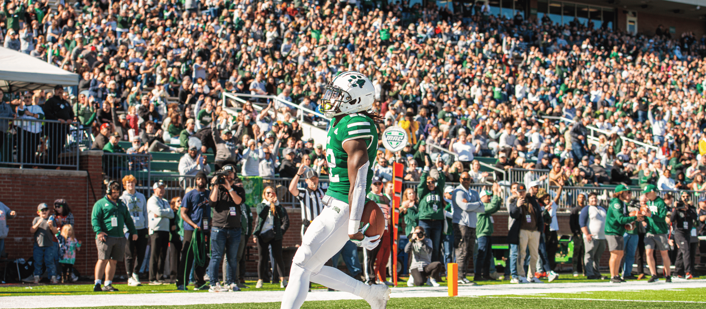 Football player celebrating with crowd in Peden