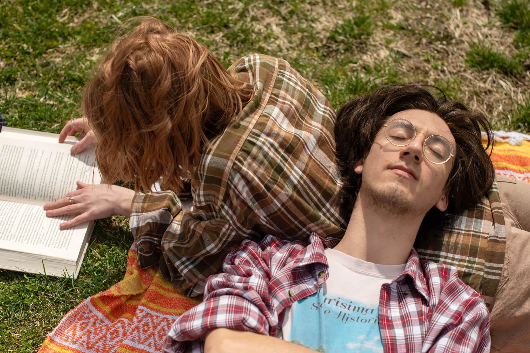 Students relax and enjoy a nice spring day lounging on the grass at Emeriti Park