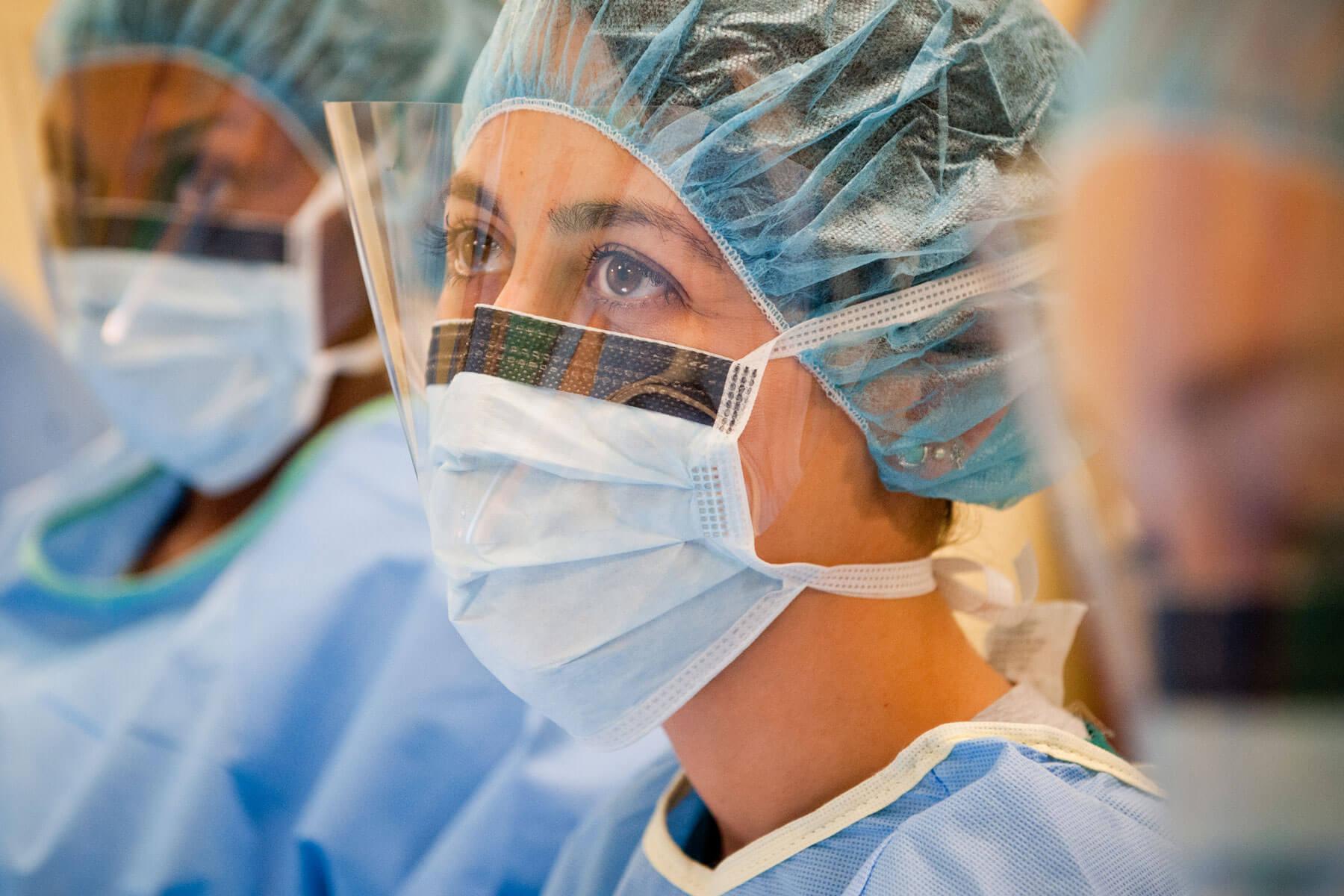 An OHIO student wearing medical scrubs is shown in a medical setting