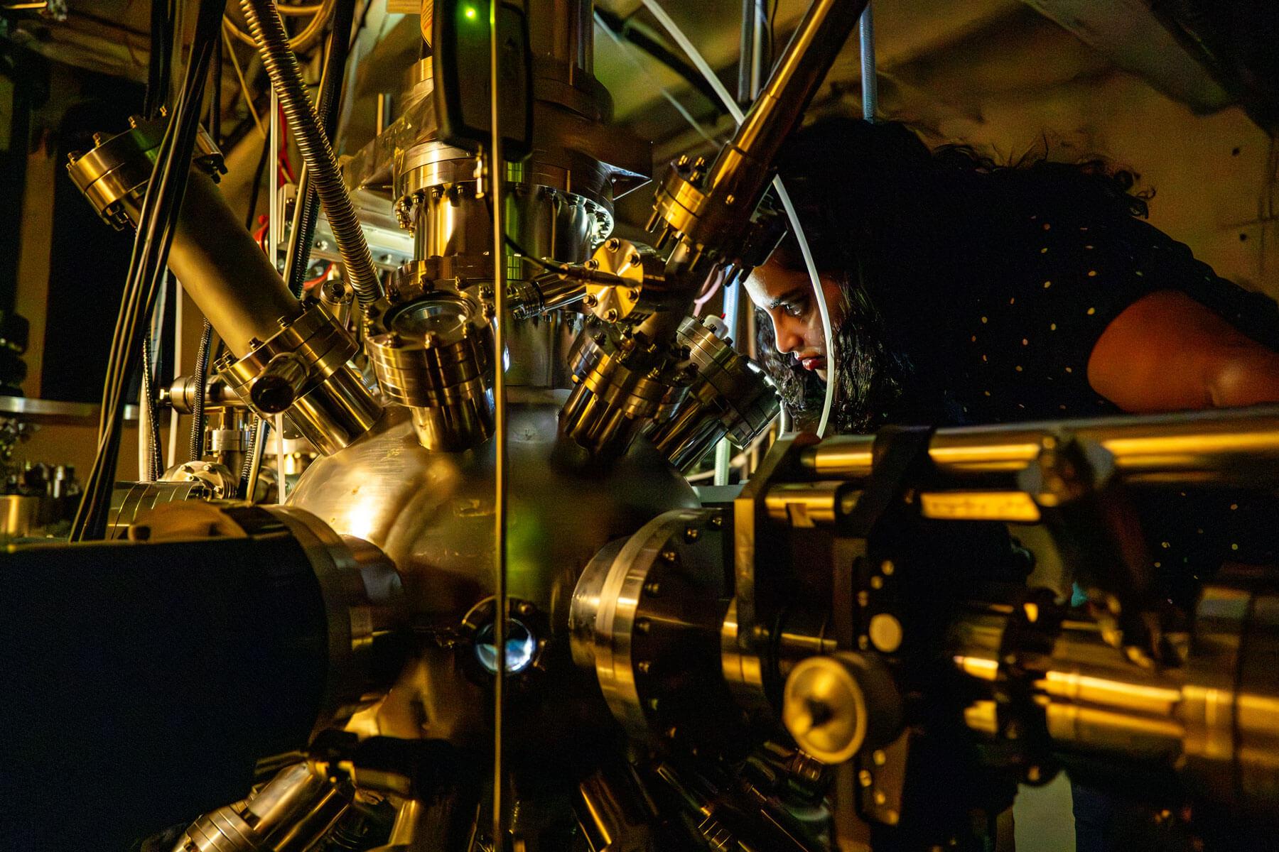 Physics Ph.D student Sneha Upadhyay in Clippinger Research Annex with equipment used to study spintronics