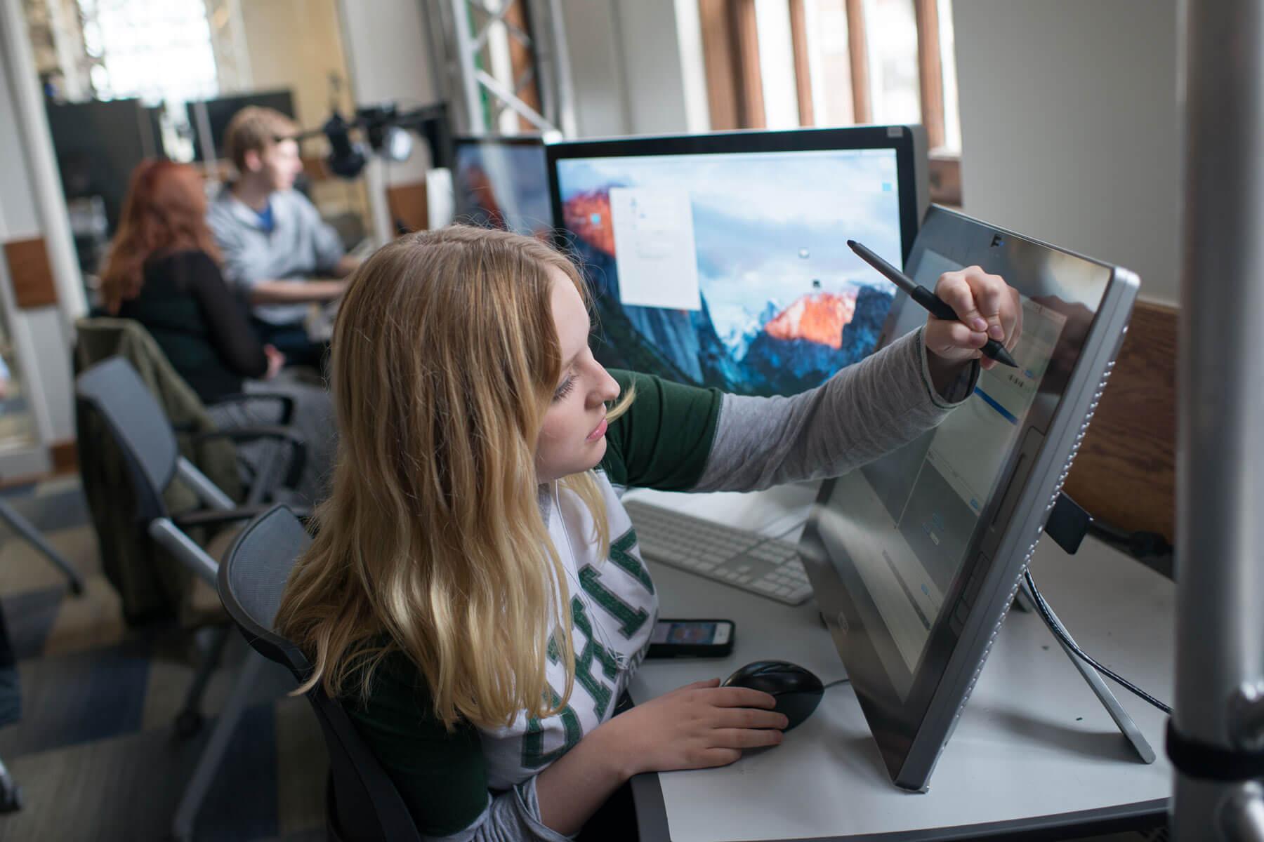 A student uses a drawing tablet in OHIO's GRID Lab