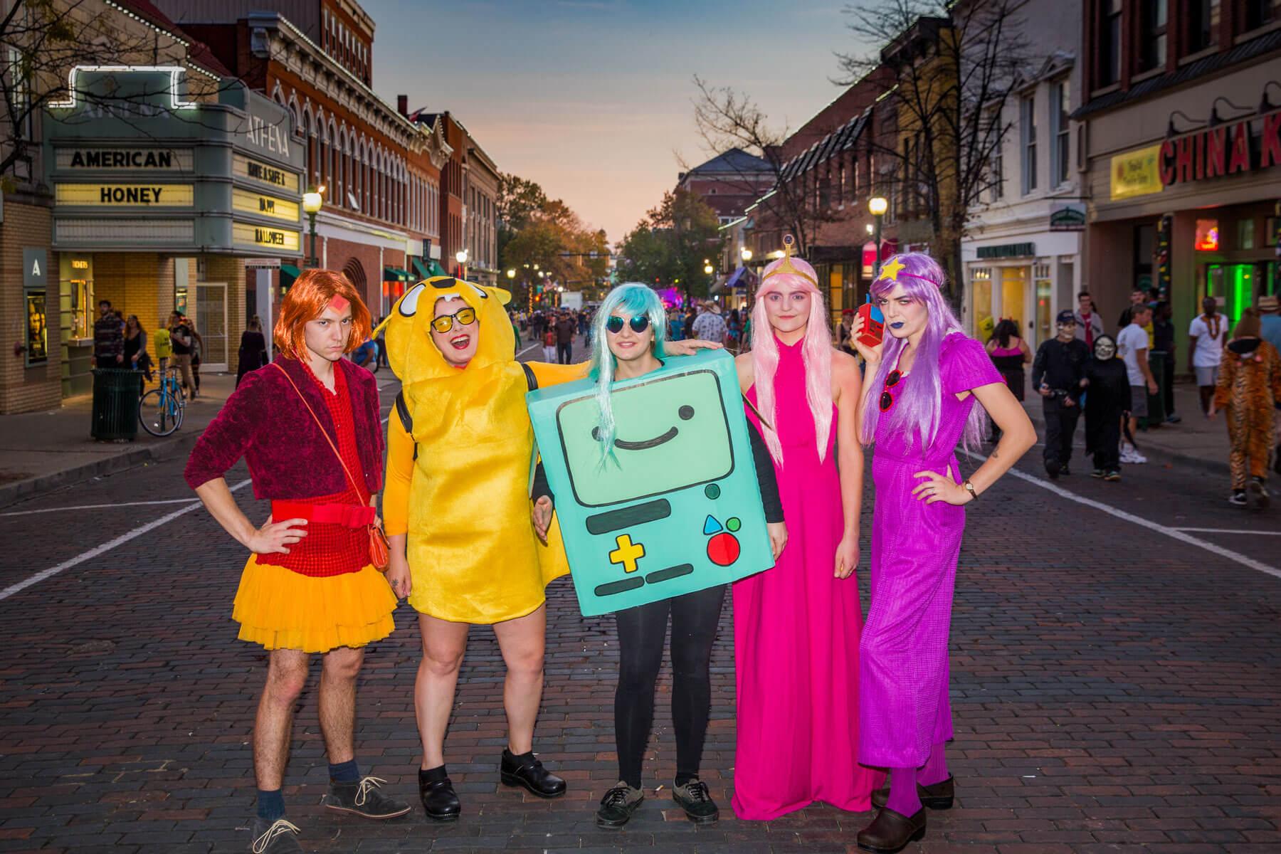 A group poses for a picture in their costumes during Athens Halloween Block Party