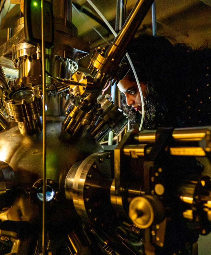 Physics Ph.D student Sneha Upadhyay in Clippinger Research Annex with equipment used to study spintronics