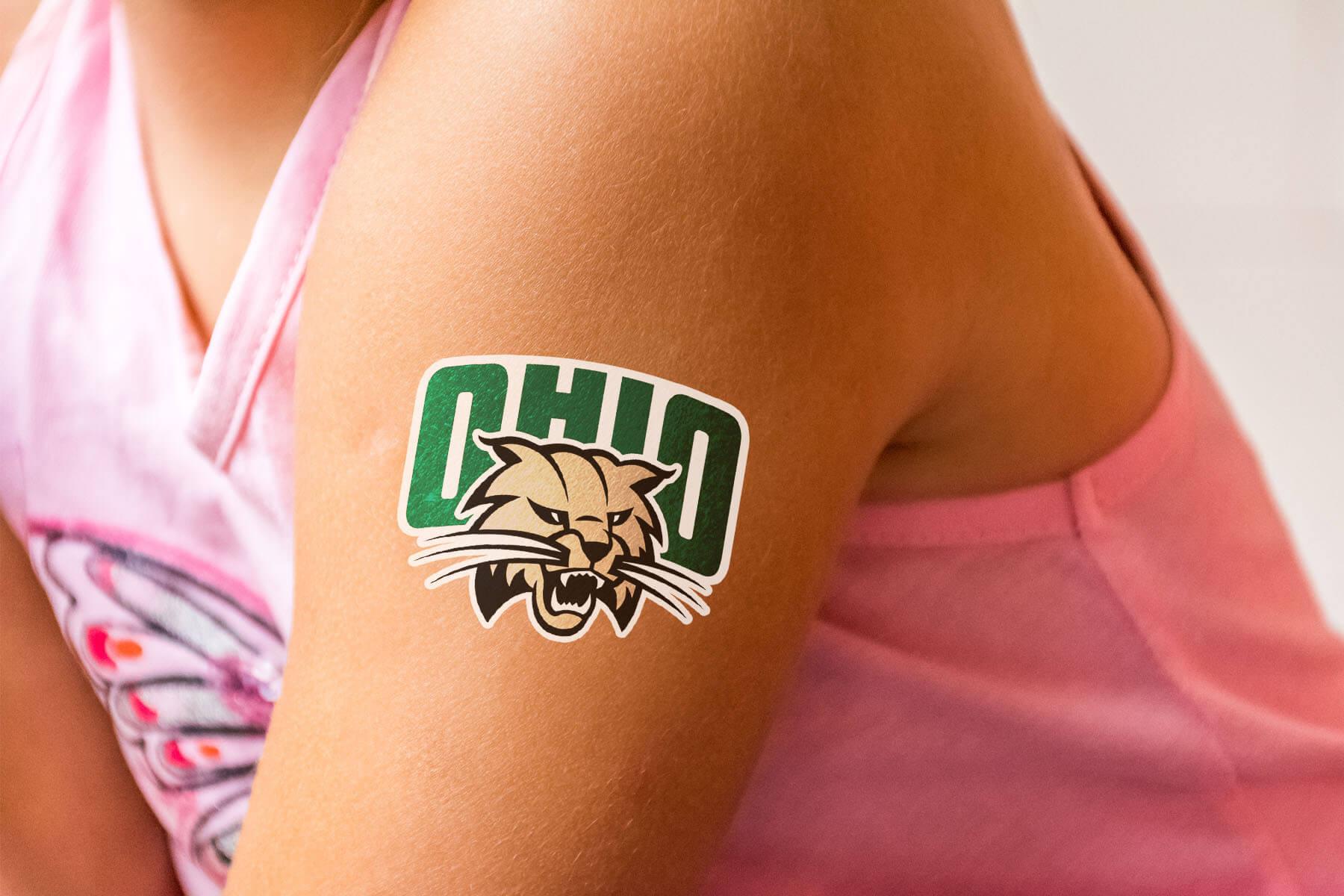 A mockup of temporary tattoo of the Ohio University Athletics logo on an arm