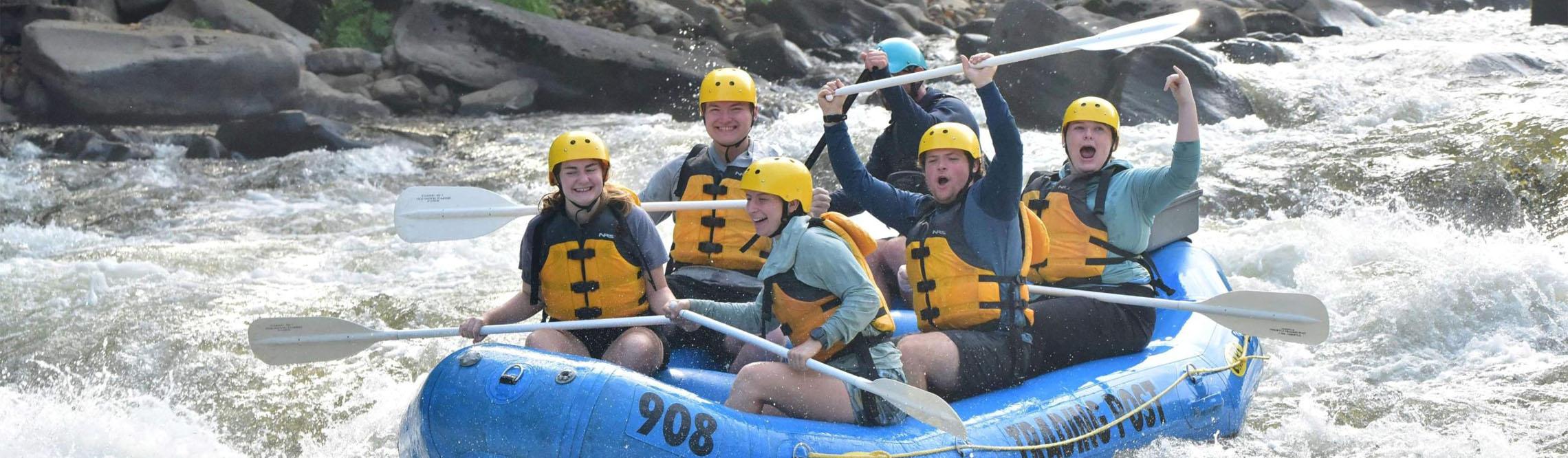 a group of students laughing and having fun on a boat trip on laurel highlands waterfall