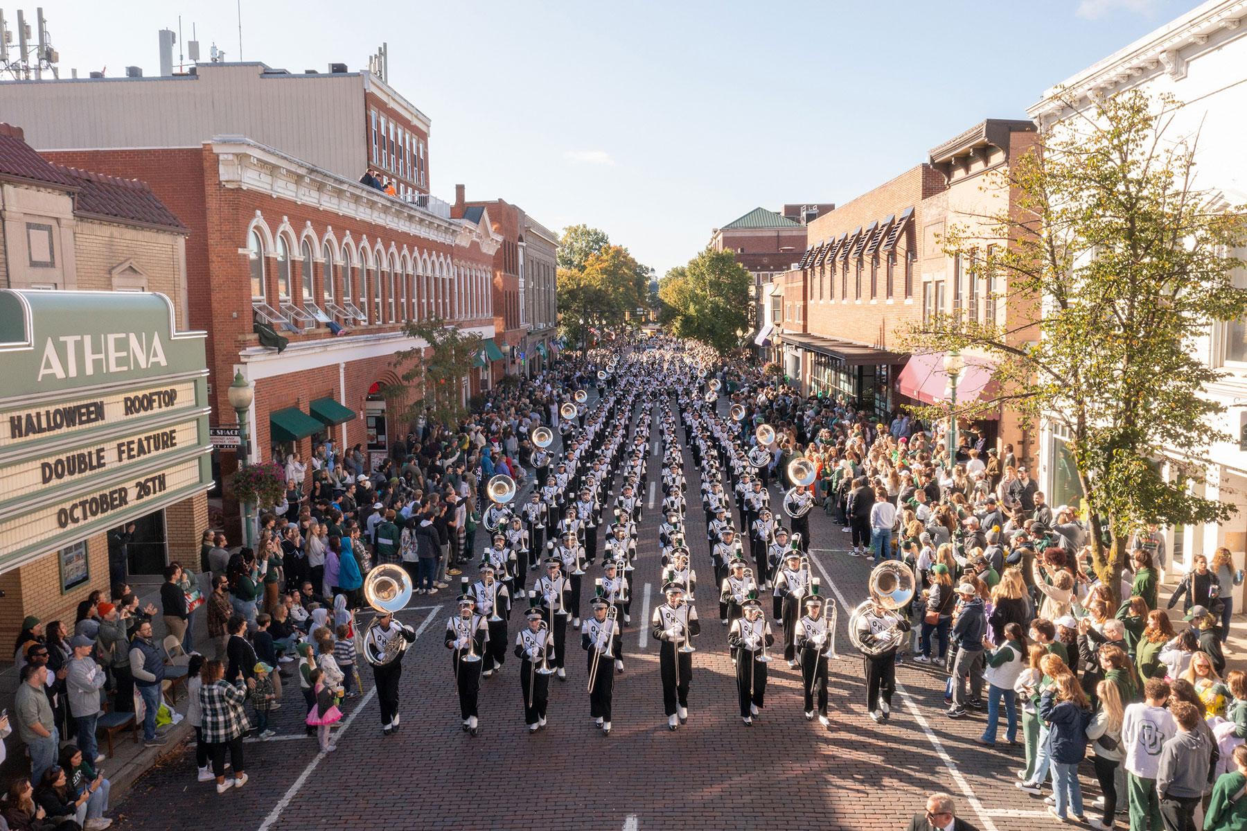 Ohio University's Marching 110 marching band parades through uptown Athens during the annual Homecoming parade
