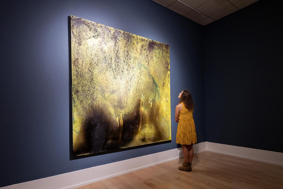 Person in front of painting in a museum gallery. 