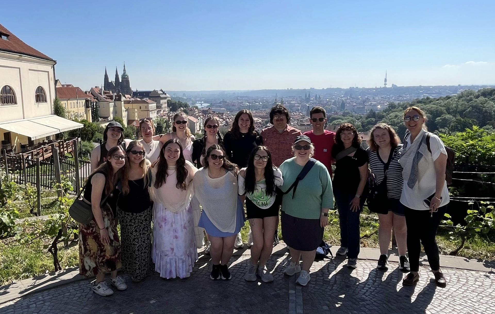 A group of Ohio University students and faculty stand in front of a overlook