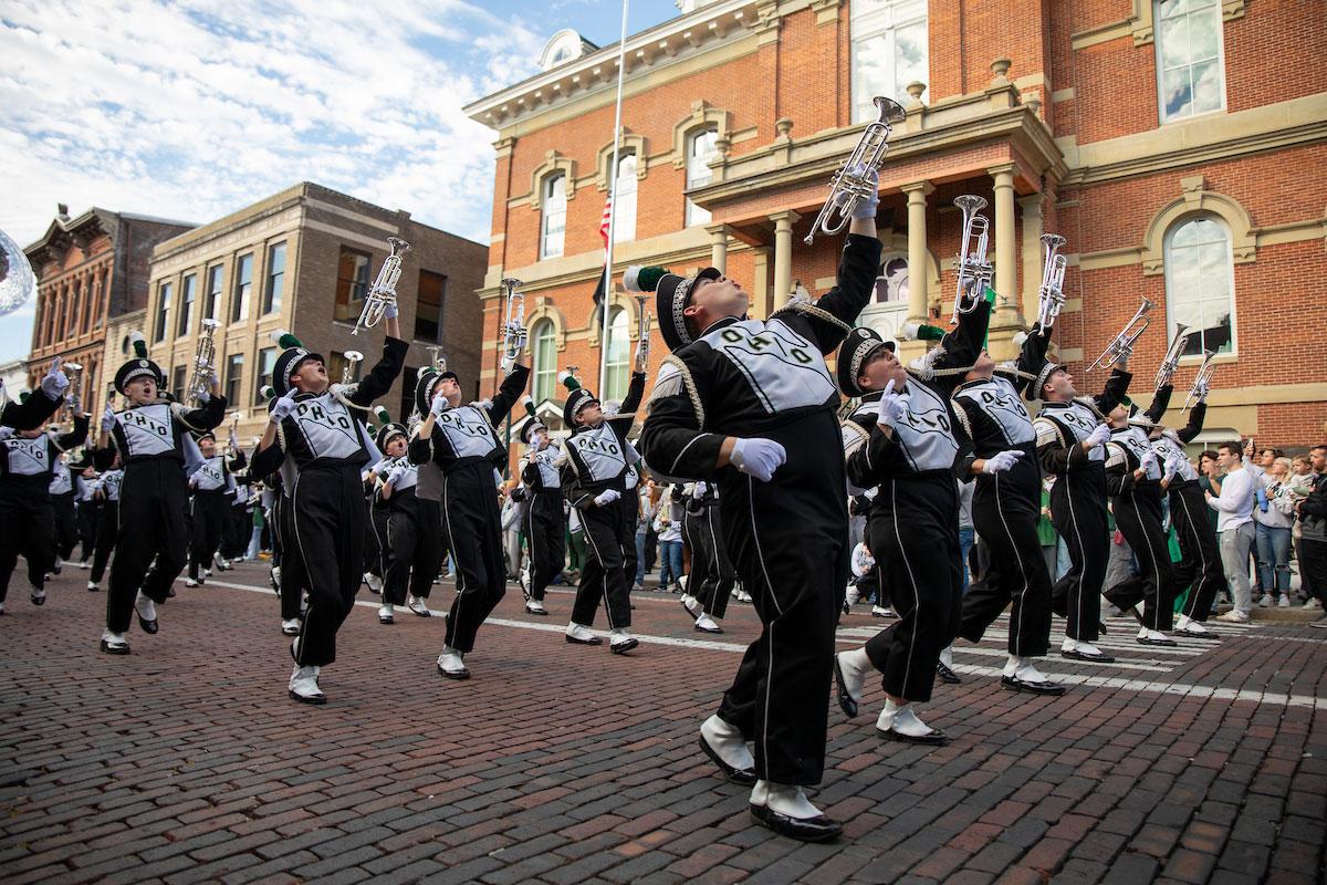 Members of the Marching 110 Ohio University marching band dance during the Homecoming parade.