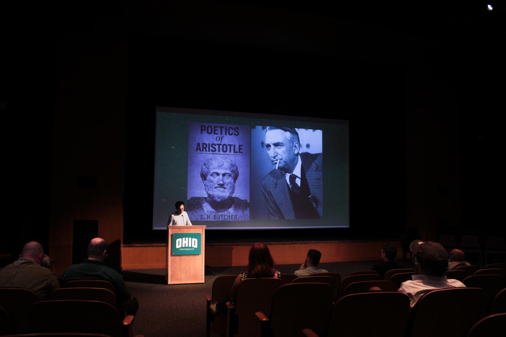 Michael Kortlander speaking to crowd in Baker theater