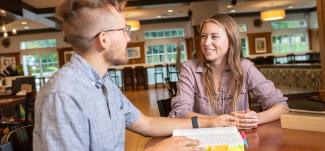 Two students talk at a café