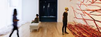People in gallery looking at art. 