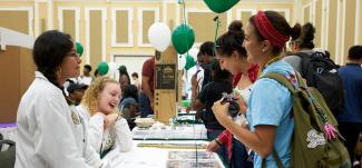 Students browse tables at the Majors Fair.