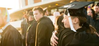 Two Ohio University students hug after Commencement