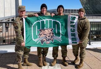 Air Force ROTC Ohio University students hold an OHIO flag in uniform