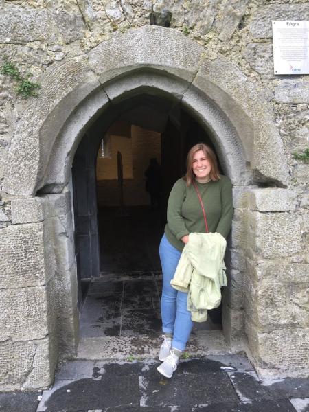 Victoria Brown standing in front of an entrance to Aughanure castle 