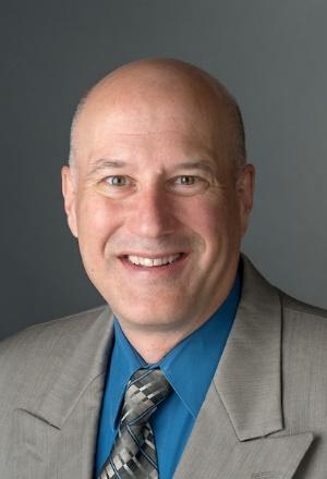 A headshot of Dr. Greg Newton