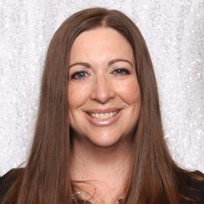 Headshot of Carissa. Shown shoulders up. She is wearing a black top