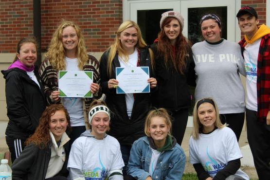 Top team and top individual fundraisers for the NEDA walk pose for a group picture.