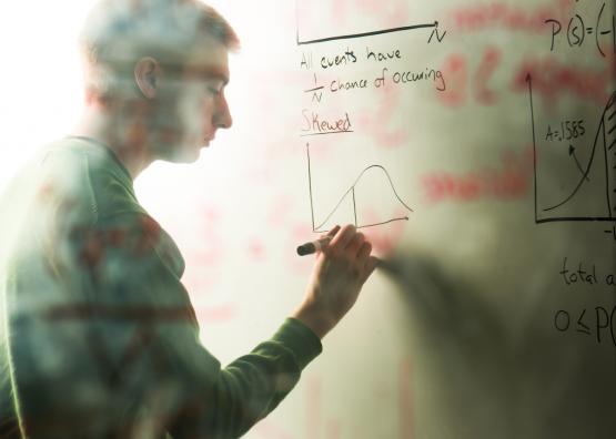Man drawing a graph on a whiteboard