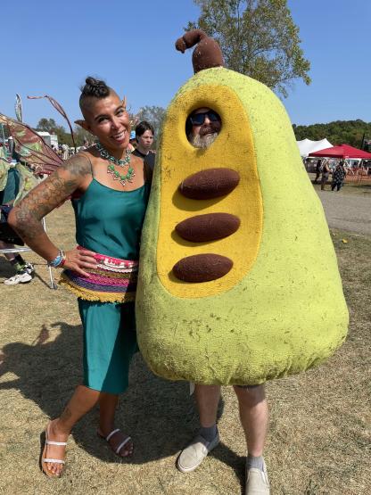 A photo of a woman with a man in a full body costume