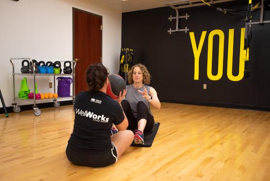 Student performing in-person personal training session