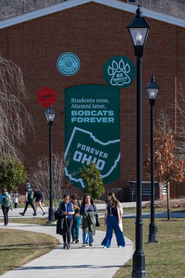 Students walking along sidewalk on Athens campus.