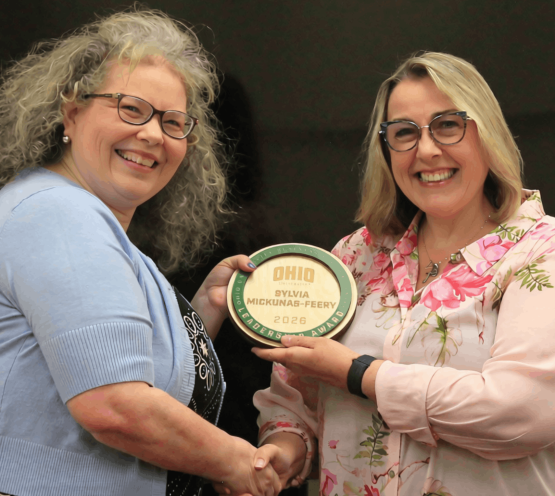Sylvia Mickunas and Heather Krugman. Sylvia is holding her award.
