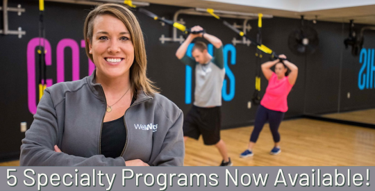 WellWorks Executive Director Jenn Bennett in front of TRX equipment