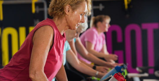 Member exercising at a Cycling class.