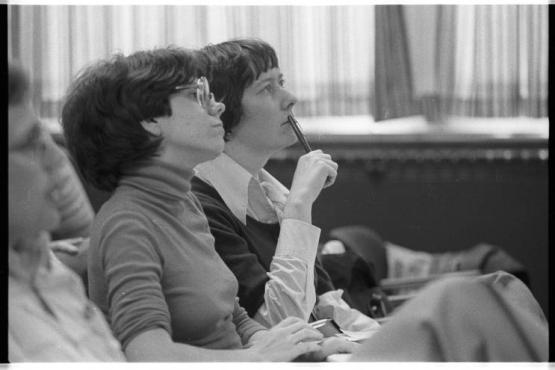 Women in class listen to a lecture.