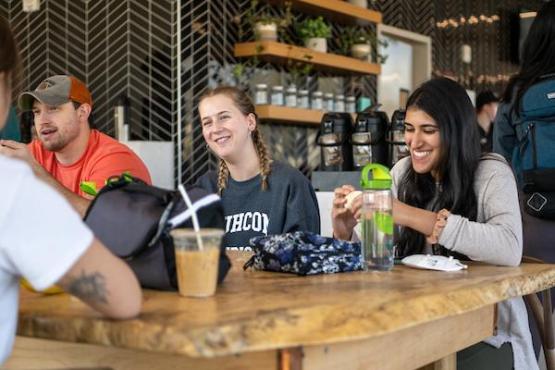 Students laugh and talk in the Cafe at Factory Street