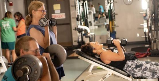 Members lifting weights at WellWorks fitness facility