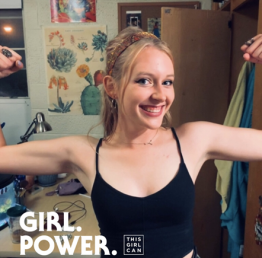 Taylor Linzinmeir flexes in a Girl Power, This Girl Can poster.