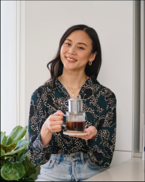 Sahra Nguyen holding coffee.