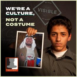 A student holds up a photo of cultural appropriation.