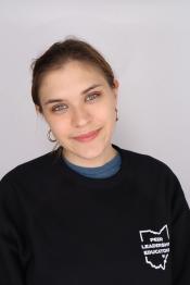 student smiles for a professional portrait