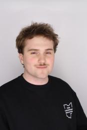 student smiles for a professional portrait