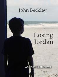 Silhouette of boy looking out at the ocean.