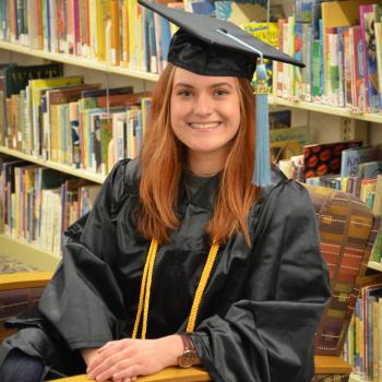 Student Gracie Gardner in a commencement robe