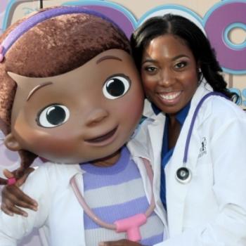 Dr. Myiesha Taylor poses with Disney's Doc McStuffins